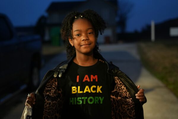 Girl with a t-shirt that says "I Am Black History".