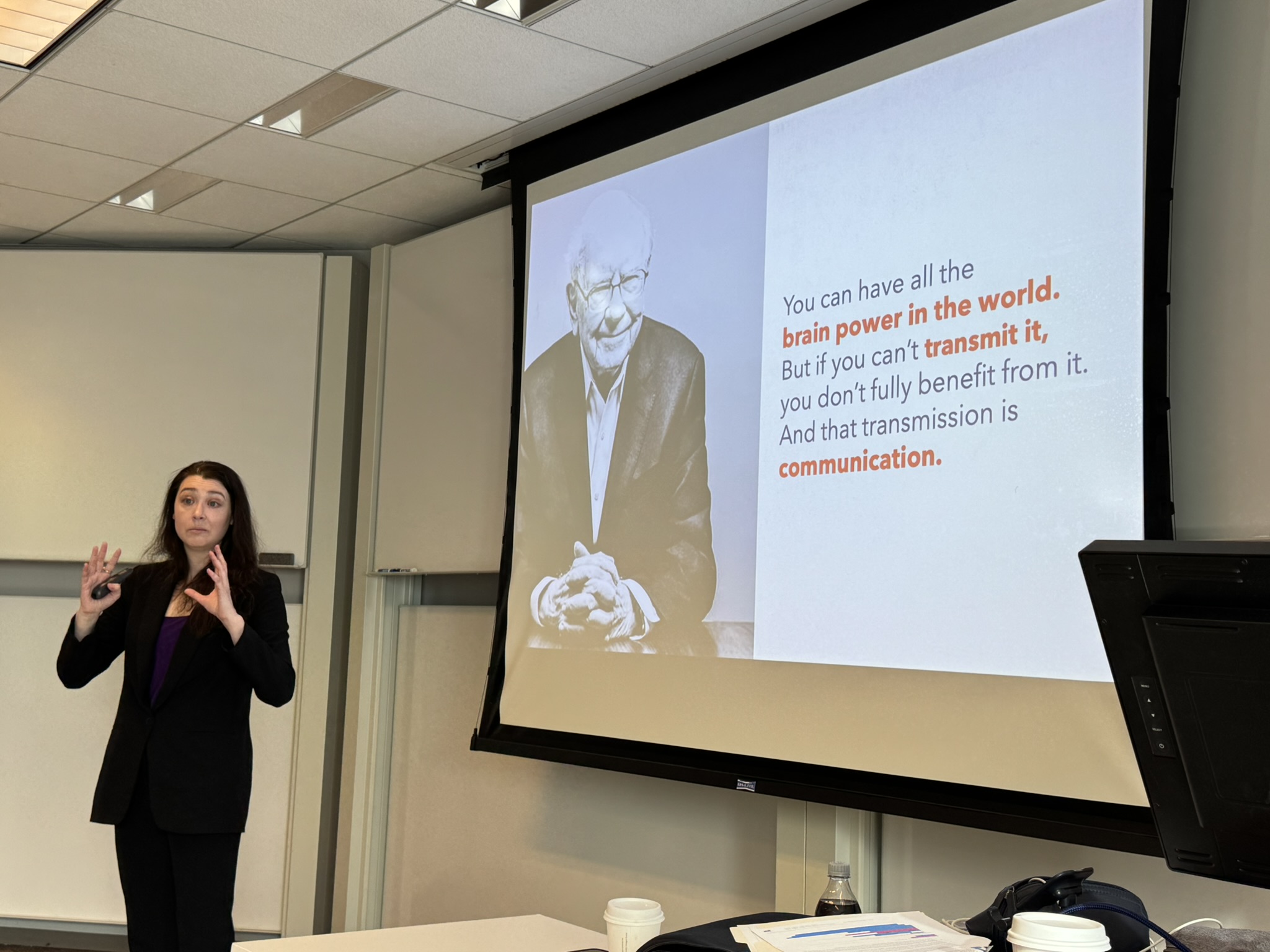 Katie Garcia speaking in front of a slideshow