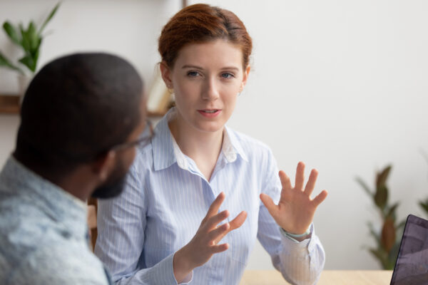 Businesswoman actively discussing a topic with a colleague