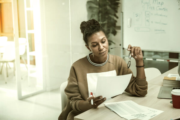 African-American office worker wearing casual clothes feeling busy preparing her speech