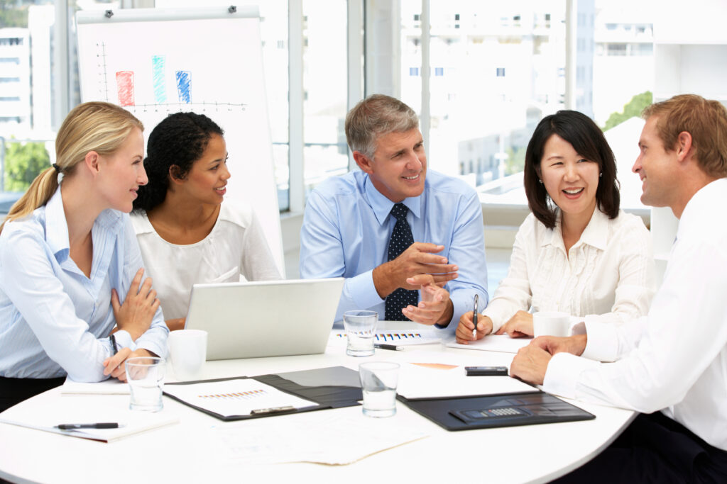 Business meeting in an office and everyone is smiling.