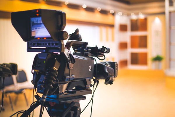 A studio camera set up to start filming in a studio.
